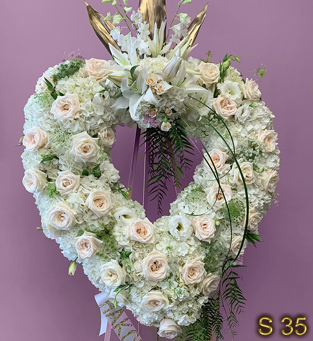 magnificent funeral arrangement sympathy open heart with white carnations and pink roses send to Forest Lawn Burbank